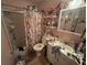 Bathroom featuring vanity, tub, and floral shower curtain at 725 6Th Ne St, Fort Meade, FL 33841