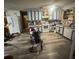 Bright kitchen with painted cabinets, white appliances, and newer vinyl floors at 725 6Th Ne St, Fort Meade, FL 33841