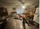 Cozy living area with wood-look vinyl flooring, natural light, and ceiling fan at 725 6Th Ne St, Fort Meade, FL 33841