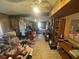 Large living room with wood paneling, tile flooring, and a ceiling fan at 725 6Th Ne St, Fort Meade, FL 33841