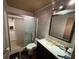 Bathroom featuring neutral colored tiling, a standup shower, and modern toilet and sink fixture at 1818 Mango Tree Dr, Edgewater, FL 32132
