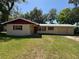 Charming one-story home with a well-maintained lawn and mature trees providing ample shade at 1818 Mango Tree Dr, Edgewater, FL 32132