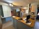Kitchen featuring a refrigerator, and lots of cabinets and counterspace with a breakfast bar area at 1818 Mango Tree Dr, Edgewater, FL 32132