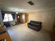 Open living room with neutral walls and a comfortable sofa, creating a relaxing ambiance at 1818 Mango Tree Dr, Edgewater, FL 32132