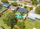 A landscape featuring a pristine swimming pool and the home's layout within a residential area at 219 Vermont Ave, St Cloud, FL 34769