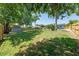 Large backyard with mature trees, wood fence, shed, and pool, offering plenty of space and privacy at 219 Vermont Ave, St Cloud, FL 34769