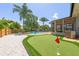 A beautifully landscaped backyard with putting green and a pool, enhancing the home's outdoor appeal at 219 Vermont Ave, St Cloud, FL 34769