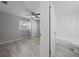 Bright bedroom with modern ceiling fan, wood-look floors, and an adjacent bathroom entrance at 219 Vermont Ave, St Cloud, FL 34769