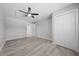 Bright bedroom featuring hard surface floors, a ceiling fan, and a spacious closet at 219 Vermont Ave, St Cloud, FL 34769