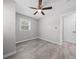 Neutral bedroom featuring a ceiling fan, window with blinds, and durable laminate flooring at 219 Vermont Ave, St Cloud, FL 34769