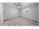 Well-lit bedroom with modern ceiling fan, window, and clean, light-toned flooring at 219 Vermont Ave, St Cloud, FL 34769