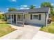 A well-kept home with a tidy front yard and a convenient driveway leading up to the entrance at 219 Vermont Ave, St Cloud, FL 34769