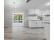 Well-lit kitchen with white cabinetry, modern appliances, and a view to the backyard at 219 Vermont Ave, St Cloud, FL 34769