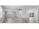 Spacious living room featuring hard surface floors, ceiling fans, and access to screened porch at 219 Vermont Ave, St Cloud, FL 34769