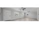 Bright living room featuring hard surface floors, ceiling fans, and a stylish front door at 219 Vermont Ave, St Cloud, FL 34769