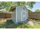 Well-maintained backyard shed with a painted exterior, white trim, and mature trees around at 219 Vermont Ave, St Cloud, FL 34769