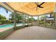 The spacious sunroom overlooks the pool and yard through large windows and has a wood ceiling at 219 Vermont Ave, St Cloud, FL 34769