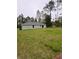 Expansive backyard view of this single-story home, offering a serene natural backdrop at 24202 Nw Aspen Ln, Dunnellon, FL 34432