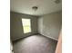 Carpeted bedroom with closet and window with views of the front yard at 24202 Nw Aspen Ln, Dunnellon, FL 34432