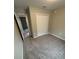 Cozy carpeted bedroom with a double door closet, neutral walls and baseboard trim at 24202 Nw Aspen Ln, Dunnellon, FL 34432