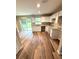 Bright kitchen featuring white cabinets, granite countertops, stainless sink, and sliding glass doors to the backyard at 24202 Nw Aspen Ln, Dunnellon, FL 34432