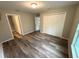 Primary bedroom featuring wood-look flooring, neutral walls, walk in closet, and ensuite bathroom at 24202 Nw Aspen Ln, Dunnellon, FL 34432