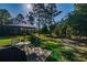 Backyard patio with outdoor dining set and umbrella, ideal for entertaining and relaxing at 9085 Sw 202Nd Avenue Rd, Dunnellon, FL 34431