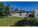 Landscaped backyard featuring a lovely patio space and green grass at 9085 Sw 202Nd Avenue Rd, Dunnellon, FL 34431