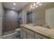 Well-lit bathroom featuring a large vanity with a marble countertop and a walk-in shower at 9085 Sw 202Nd Avenue Rd, Dunnellon, FL 34431