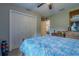 Comfortable bedroom with large closet, ceiling fan, dresser, and view into the dining area at 9085 Sw 202Nd Avenue Rd, Dunnellon, FL 34431