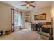 Bedroom with plush carpet, ceiling fan, and window providing natural light at 9085 Sw 202Nd Avenue Rd, Dunnellon, FL 34431