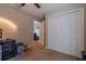 Bedroom showcasing large closet, carpeted floors, and access to living area at 9085 Sw 202Nd Avenue Rd, Dunnellon, FL 34431