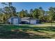 Charming home featuring an extra building, beautiful lawn, and long driveway at 9085 Sw 202Nd Avenue Rd, Dunnellon, FL 34431