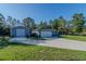Charming home featuring an extra building, beautiful lawn, and long driveway at 9085 Sw 202Nd Avenue Rd, Dunnellon, FL 34431