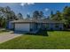 Charming home with a two-car garage, well-manicured lawn, and appealing facade at 9085 Sw 202Nd Avenue Rd, Dunnellon, FL 34431