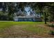 Well-maintained house with a large front lawn and mature trees, enhancing curb appeal at 9085 Sw 202Nd Avenue Rd, Dunnellon, FL 34431