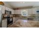 Kitchen with stainless steel appliances, granite counters, and wood cabinets at 9085 Sw 202Nd Avenue Rd, Dunnellon, FL 34431