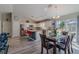 Open-concept kitchen features island seating, stainless appliances, dining area and backyard views at 9085 Sw 202Nd Avenue Rd, Dunnellon, FL 34431