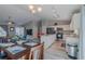 Bright kitchen open to the dining area boasts white cabinets and stainless appliances at 9085 Sw 202Nd Avenue Rd, Dunnellon, FL 34431