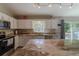 Bright kitchen with white cabinets, granite countertops, and stainless steel appliances at 9085 Sw 202Nd Avenue Rd, Dunnellon, FL 34431
