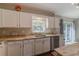 Bright kitchen showcasing stainless appliances, granite counters, and backyard views at 9085 Sw 202Nd Avenue Rd, Dunnellon, FL 34431