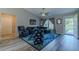 Living room with gray walls, vaulted ceiling, wood floors, and a view to the front yard at 9085 Sw 202Nd Avenue Rd, Dunnellon, FL 34431