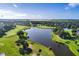 Expansive aerial view of the golf course, lake, and surrounding residential area, showcasing the landscape at 2960 Boating Blvd, Kissimmee, FL 34746