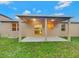 Backyard with a covered patio and well-maintained lawn for relaxation at 2960 Boating Blvd, Kissimmee, FL 34746