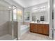 Bathroom featuring a glass shower, soaking tub, and dual sink vanity at 2960 Boating Blvd, Kissimmee, FL 34746
