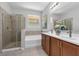 Bathroom featuring a glass shower, soaking tub, and dual sink vanity at 2960 Boating Blvd, Kissimmee, FL 34746