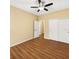 Bedroom featuring a ceiling fan, wood-look laminate flooring, and closet space at 2960 Boating Blvd, Kissimmee, FL 34746