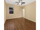 Bedroom features a window, ceiling fan, and wood-look laminate flooring at 2960 Boating Blvd, Kissimmee, FL 34746