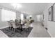 Bright dining room with a modern table, plush rug, and cohesive design elements at 2960 Boating Blvd, Kissimmee, FL 34746