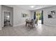 Bright dining room with tile floors, stylish chandelier, and sliding glass doors at 2960 Boating Blvd, Kissimmee, FL 34746
